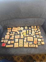 Full group of 71 wood-mounted rubber stamps on sofa