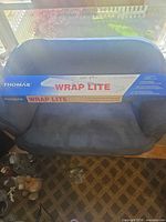 Box showing Thomas Wrap Lite branding on couch