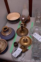 Top view of the entire group showing five candle holders and the small bronze barrel on a table.