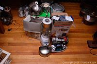 Overall view of the lot showing various boxed and unpacked appliances.