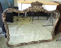Full view of ornate gold gilt mirror front