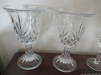 Two large flared crystal water goblets on pedestal bases