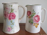Front view of both floral ceramic pitchers