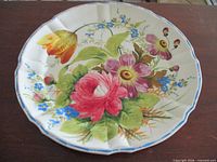 Full view of charger showing floral design and scalloped rim