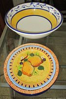 Top view of bowl and stack of plates showing designs