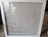 Front view of shadow box artwork showing text and frame