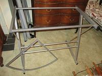 Overall view of silver metal desk frame without glass