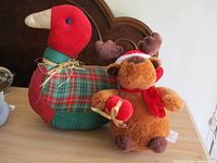 Goose and reindeer plush together on tabletop