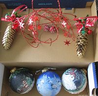 Full set showing three ball ornaments, two pinecones, red wire swirl, red berry picks