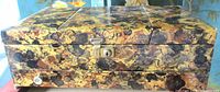 Closed marbled jewelry box exterior showing lock and missing lower drawer pull