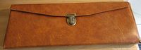 Closed brown faux leather wallet with clasp