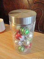 Full jar with lid showing ornaments inside