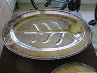 Top view of silverplate meat tray showing tree well design and gadroon edge