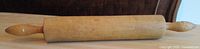 Full view of wooden rolling pin on table