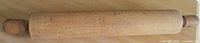 Full view of wooden rolling pin showing barrel and handles