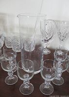 Front view of pitcher, stir rod, six wine glasses
