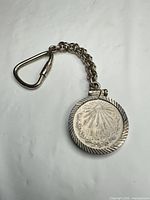 Full view of coin keychain with chain and carabiner
