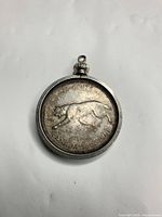 Reverse of coin pendant showing bobcat and date 1867-1967