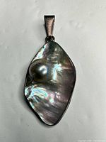 Front view of pendant showing iridescent abalone shell and bezel