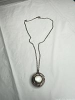 Full view of pendant necklace laid flat showing chain and pendant