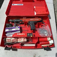 Open case showing Hilti DX36M tool, brush, fasteners, loads, accessories