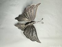 Front view showing full butterfly filigree design