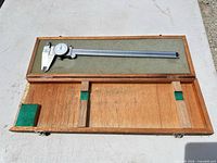 Caliper inside open wooden case
