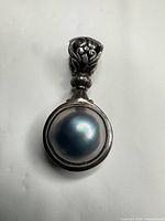 front view showing cabochon and ornate bail