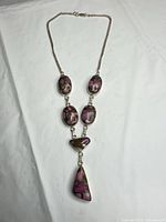 Full view of sterling silver Y-pendant necklace showing chain, three oval stones and double drop