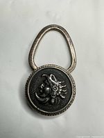 Front view of purse hook showing indigenous head design