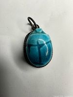 Front view of blue scarab stone set in silver bezel
