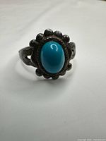 Front view of ring showing turquoise cabochon and bezel design