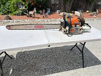 Full view of Stihl MS461 chainsaw on table with long bar attached