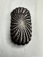 front view closed showing ornate shell motif and oxidized finish