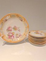 serving plate on stand beside stack of eight side plates