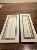 Both white recessed vents side by side on table