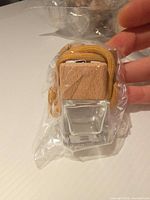 front view sealed diffuser bottle showing glass body, wood cap, yellow cord