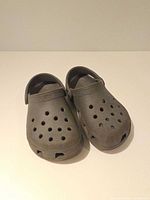 Front view of gray Crocs showing toe ventilation holes and overall wear