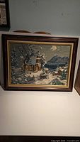 Full view of framed needlepoint artwork
