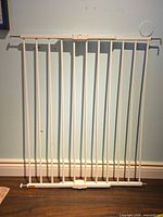 Full view of white metal safety gate standing upright