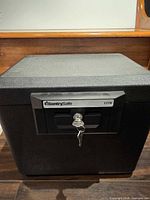 Front view of SentrySafe 1170 safe showing lock and keys