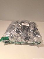 Factory-sealed bag of multiple clear jars with black lids