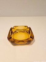Top view of amber glass ashtray showing shape and color