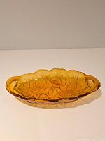 Top view of amber pressed glass bowl showing full shape and pattern