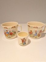 Front view of two Bunnykins cups and mini cup
