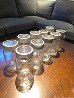 Front view of 10 jars showing lids and bands