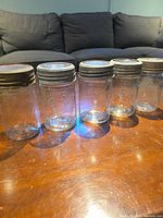All five Crown pint mason jars lined on table