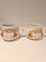 Two ceramic Chicken Soup recipe mugs side by side