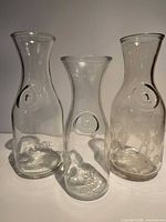 Front view of the three glass carafes displaying form and relative sizes