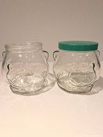 Both clear pressed-glass bear jars side by side